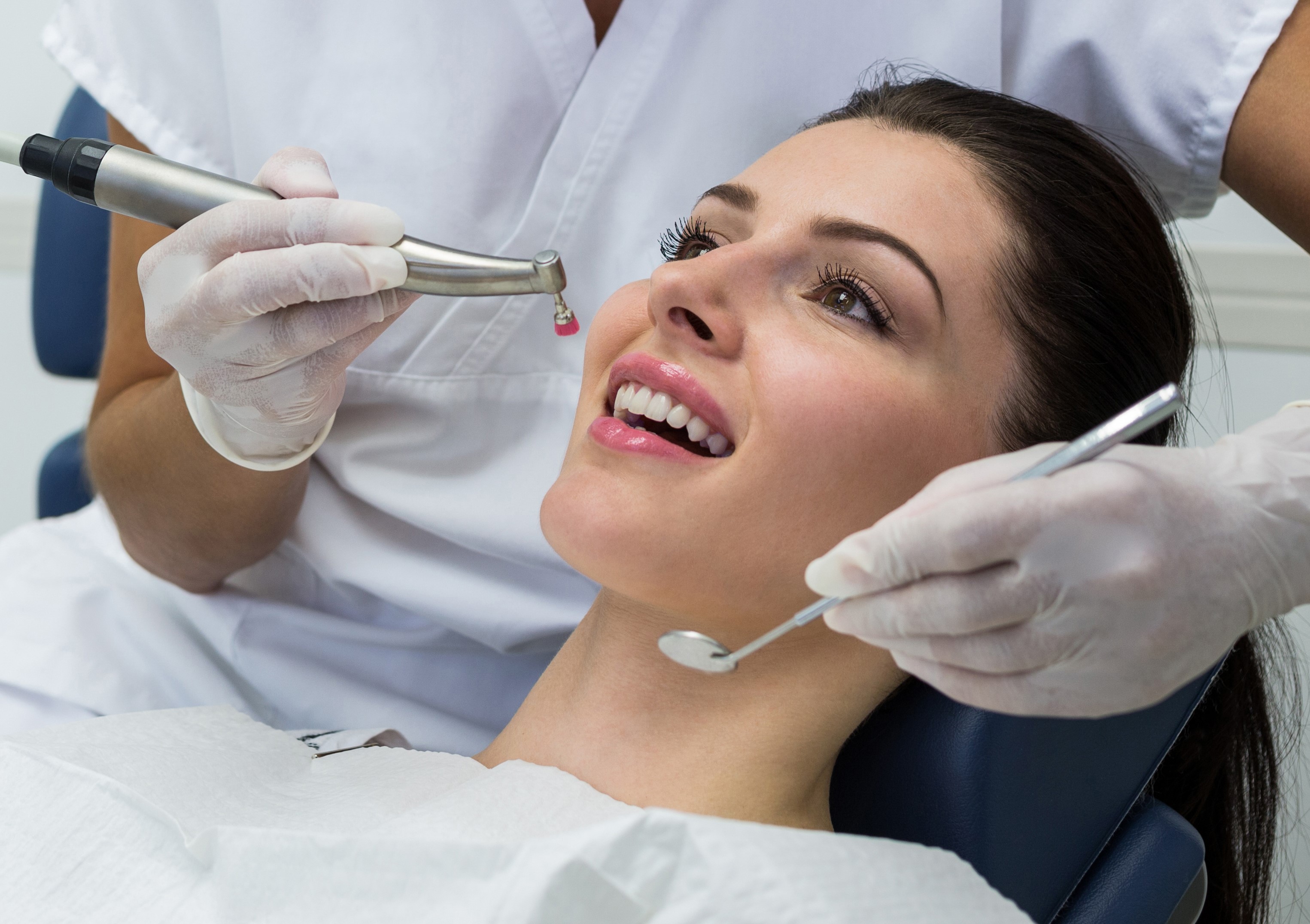 dentist-examining-female-patient-with-tools.jpg
